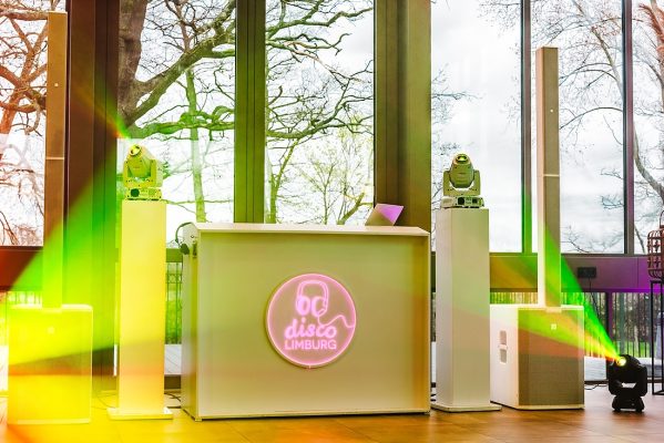 DJ Booth met gele verlichting en logo Disco Limburg